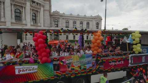 VIENNA AUSTRIA June 16 2018 – LBGT rainbow parade, gay pride parade, Regenbogenparade at the Ringstrasse Wien, wide shot of party truck with music passing by, background Burgtheater, with sound