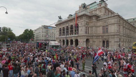 VIENNA AUSTRIA June 16 2018 LBGT rainbow parade, gay pride parade, Regenbogenparade at the Ringstrasse Wien, wide high shot of spectators watching a party truck passing by the State Opera House, sound