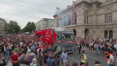 VIENNA AUSTRIA June 16 2018 LBGT rainbow parade, gay pride parade, Regenbogenparade at the Ringstrasse Wien, high shot of people following a party truck passing the Opera House, many spectators, sound