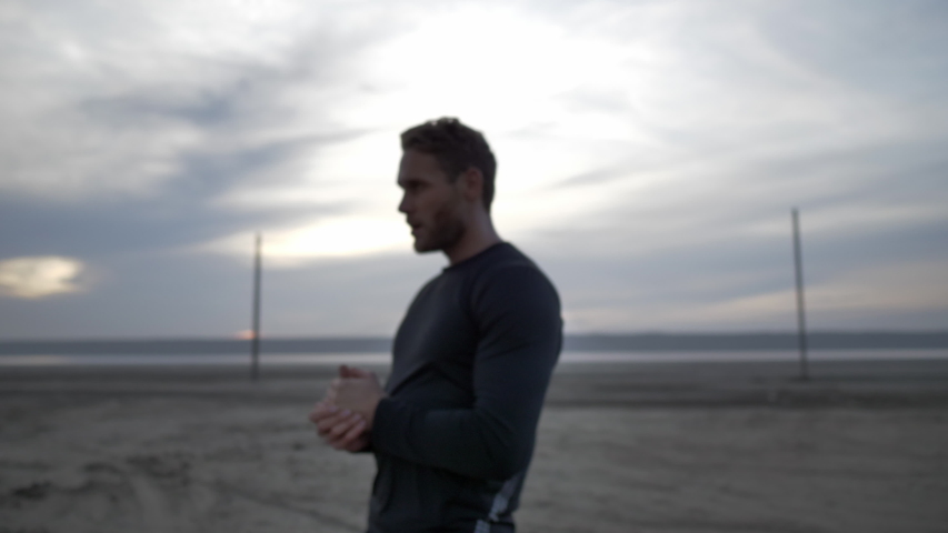 
Young athlete mopping face after workout.
