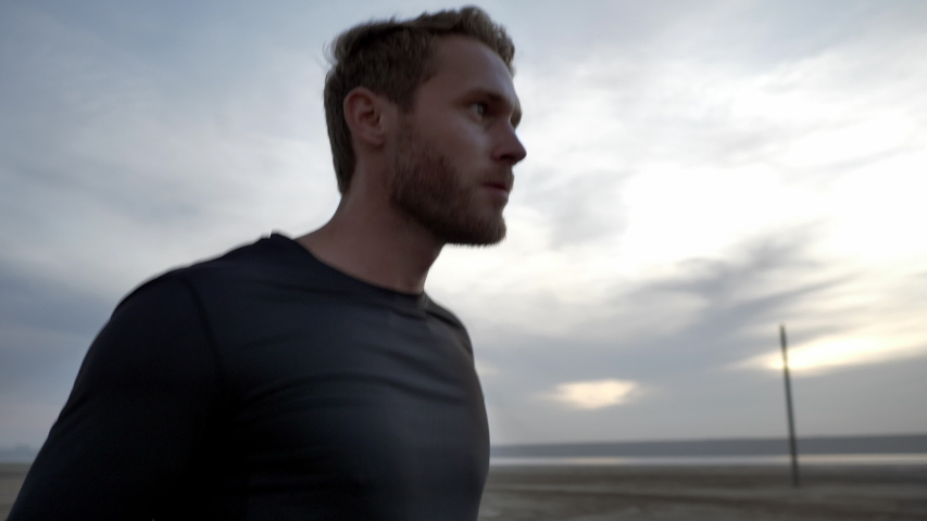 
Close up video of a handsome young athlete training using jumping rope on a beach.
