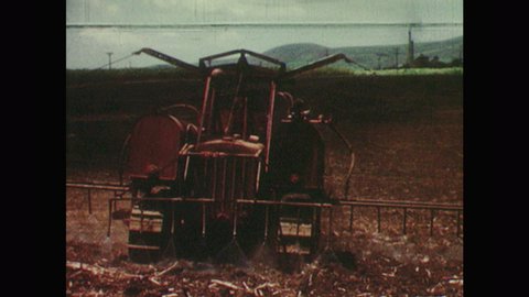 1950s: Tractor sprays chemicals on sugarcane field. Crop-duster drops chemicals onto sugarcane fields. Men spray chemicals on field with backpack sprayers.