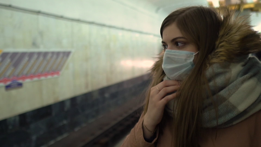 Ill woman  feeling sick, coughing, wearing protective mask against transmissible infectious diseases and as protection against the flu in public transport or subway. New coronavirus 2019-nCoV China
 Royalty-Free Stock Footage #1046646493