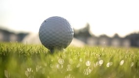 Golf club hits a golf ball in a super slow motion. Drops of morning dew and grass particles rise into the air after the impact. - Powered by Shutterstock - Get 15% off with code: PIKWIZARD15