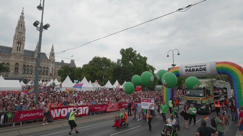 VIENNA AUSTRIA June 16 2018 – LBGT rainbow parade, gay pride parade, Regenbogenparade at the Ringstrasse Wien, party truck passing by Burgtheater, background spectators and town hall city hall, sound