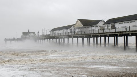 Storm Eunice waves crashing against a traditional English wooden pier in Southwold UK Stunning Slow motion footage 4K