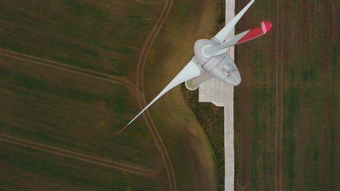 Spinning Wind Turbines On Beautiful Sunset Autumn Landscape. Green Ecological Power Energy Generation. Wind Turbines Farm Eco Field. Sunrise Above Windmills On Field. Aerial View. Energy Production.