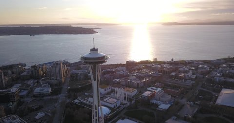 Seattle, Washington, United States - February 3, 2020: Aerial drone flight over Seattle Washington at sundown.  The Space Needle is centred in the frame against the setting sun.