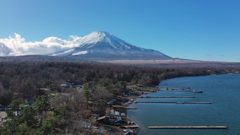 Aerial view of Mount Fuji, iconic snow-capped symbol of Japan, lake Yamanaka, clear blue sky - landscape panorama of Japan from above, Asia