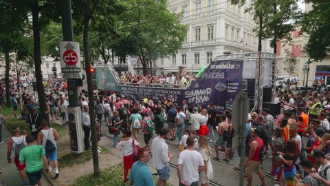 VIENNA AUSTRIA June 16 2018 LBGT rainbow parade gay pride parade, Regenbogenparade at the Ringstrasse Wien, moving Segway shot of people marching along a party truck with spectators dancing, sound
