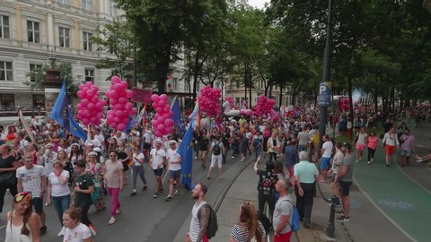 VIENNA AUSTRIA June 16 2018 LBGT rainbow parade gay pride parade, Regenbogenparade at the Ringstrasse Wien, moving Segway shot of people dancing on the street waving rainbow flags, sound