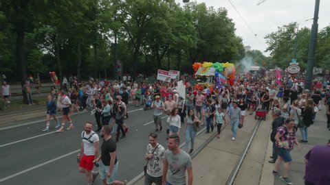 VIENNA AUSTRIA June 16 2018 LBGT rainbow parade gay pride parade Regenbogenparade at the Ringstrasse Wien, wide high master shot of Ringstraase with people und music trucks coming along, with sound