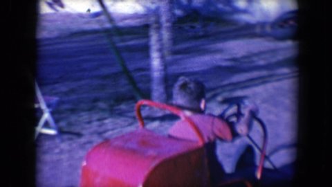 TUCSON ARIZONA USA-1958: Boy Riding A Red Toy Car In The Playground