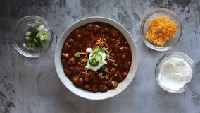 Serving a Bowl of Chili with Beans on a concrete background with room for copy