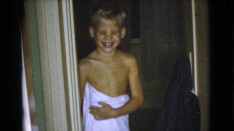 COTTONWOOD ARIZONA-1968: A Blond Haired Boy Smiling Brightly In A Doorway Of A Home
