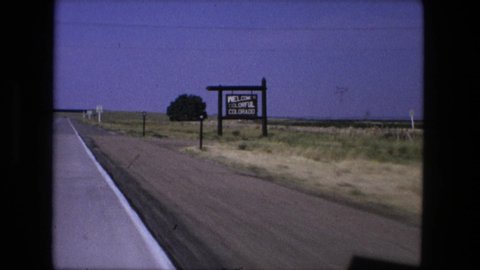 FORT WAYNE INDIANA-1976: Driving Along A Road With Massive Fields On Both Sides Of The Road And A Road Sign