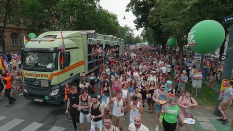 VIENNA AUSTRIA June 16 2018 LBGT rainbow parade gay pride parade, Regenbogenparade at the Ringstrasse Wien, moving Segway shot of a big crowd dancing on the street next to a party truck, sound