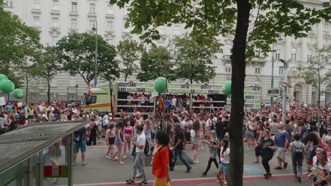 VIENNA AUSTRIA June 16 2018 LBGT rainbow parade gay pride parade Regenbogenparade at the Ringstrasse Wien, wide high moving shot of Ringstrasse following dancing people and music truck, with sound