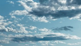 Clouds timelapse blue sky and white fluffy puffy heavenly clouds. Nature background of peaceful cloud moving across sky. Blue sky white clouds time lapse 4k video. Beautiful landscape natural backdrop