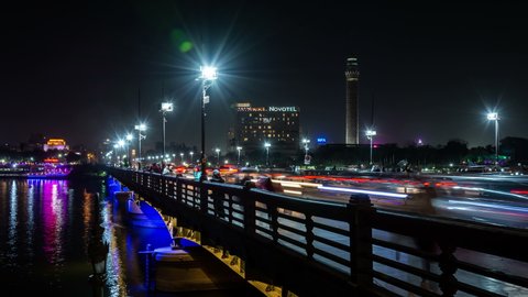 CAIRO, EGYPT - CIRCA 2020: The Qasr El Nil bridge over the Nile river in central Cairo. Night time lapse video. Car traffic, light trails.