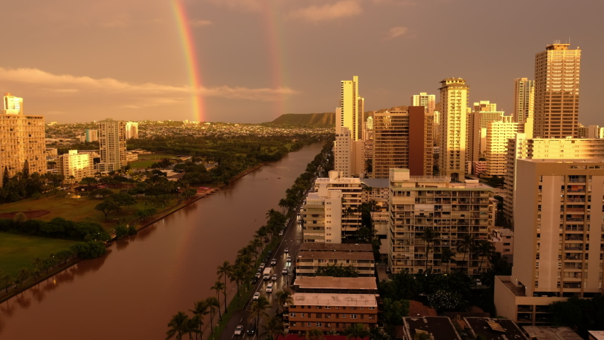 The city of Honolulu with the rainbow in the sky at sunset. Hawaii, USA