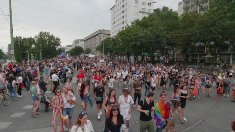 VIENNA AUSTRIA June 16 2018 LBGT rainbow parade gay pride parade, Regenbogenparade at the Ringstrasse Wien, moving Segway shot of people marching on the street dancing next to music trucks, with sound