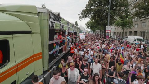 VIENNA AUSTRIA June 16 2018 LBGT rainbow parade gay pride parade, Regenbogenparade at the Ringstrasse Wien, moving Segway shot of a large crowd dancing on the street next to a party truck, with sound