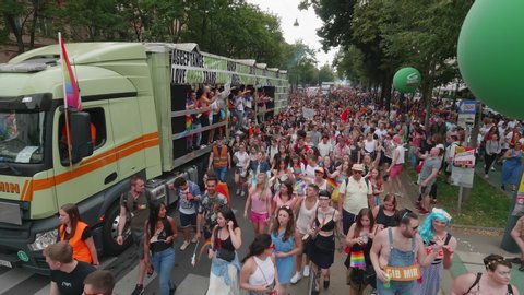 VIENNA AUSTRIA June 16 2018 LBGT rainbow parade gay pride parade Regenbogenparade at the Ringstrasse Wien, wide high master shot of Ringstrasse with people and music trucks coming to the camera, sound