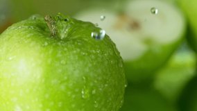 Super Slow Motion Shot of Water Drops Falling on Fresh Green Apple at 1000fps. - Powered by Shutterstock - Get 15% off with code: PIKWIZARD15
