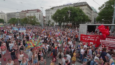 VIENNA AUSTRIA June 16 2018 LBGT rainbow parade gay pride parade Regenbogenparade at the Ringstrasse Albertina Wien moving Segway dolly shot people marching on the street next to a music truck, sound