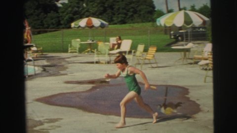 YELLOWSTONE WYOMING USA-1971: Young Child Running And Jumping In To A Recreational Pool