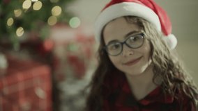 Close up portrait of smiling girl wearing eyeglasses and santa hat on Christmas / Orem, Utah, United States