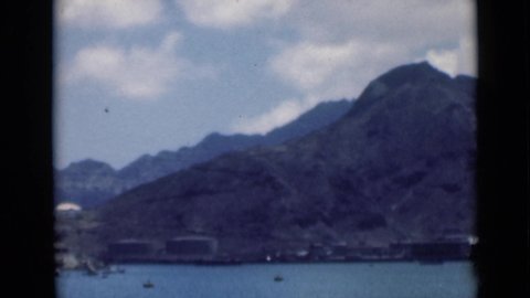 ADEN YEMEN-1946: An Expansive View Of A Body Of Water With Large Mountains In The Background With Boats In The Water