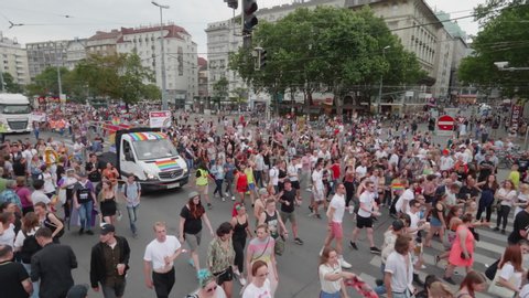 VIENNA AUSTRIA June 16 2018 LBGT rainbow parade gay pride parade, Regenbogenparade at the Ringstrasse Albertina Wien, moving Segway shot of people marching on the street next to a party truck, sound