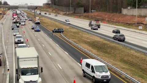 Westbound traffic passes vehicles that were involved in a traffic accident on Interstate 66 in Fairfax, VA on December 2, 2019. The accident caused delays which impacted rush hour traffic. 