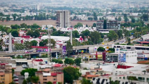 Puebla, Mexico, June 3, 2019 - High view time lapse of daily traffic in San Andres Cholula with bridge of Recta a Cholula (Via Volkswagen) Tilt Shift Miniature Looks.