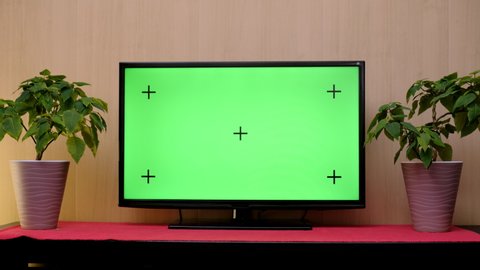 TV with green screen composited. TV or television - green screen - room - on the table. LCD TV with track green screen in modern livingroom