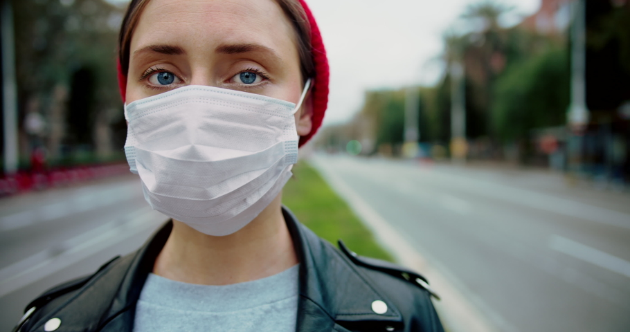 Pandemic Covid-19 coronavirus protection. Portrait of a european hipster woman wearing protective mask street.Concept of health and safety life, N1H1 coronavirus, virus protection.Cinematic Closeup Royalty-Free Stock Footage #1046801650