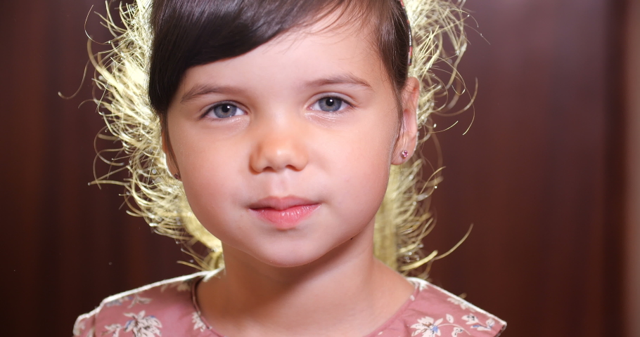 Close-up portrait of a little European girl of preschool age with brown hair and blue eyes in pink dress sneezing and blowing her nose covering nose with white handkerchief. 4k 50 fps slow motion Royalty-Free Stock Footage #1046809105