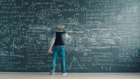 Zoom-in time-lapse of smart person solving scientific problem writing formulas on chalkboard focused on studies. People and knowledge concept.