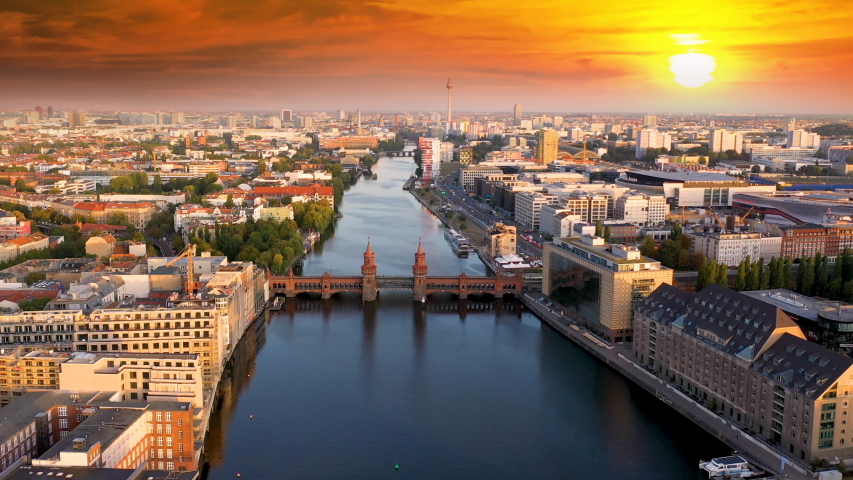 Berlin aerial skyline  view at sunset, fly over river and bridge in city centre germany. Berlin panorama.
