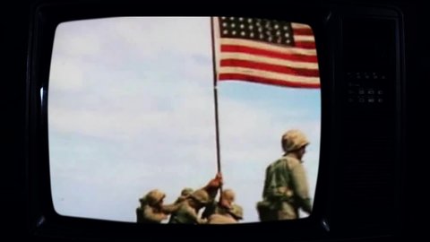 US Soldiers Raising the Flag on Iwo Jima on a Retro TV. Public Domain Film from the US Army. Dark Tone.