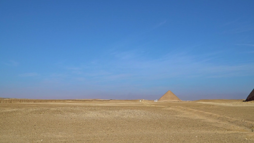 The Bent Pyramid is an ancient Egyptian pyramid located at the royal necropolis of Dahshur, approximately 40 kilometres south of Cairo, built under the Old Kingdom Pharaoh Sneferu. Egypt