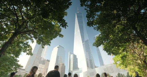 Manhattan, New York - September 17, 2019: People visit One World Trade Center and the 911 memorial park and museum in lower Manhattan New York City USA