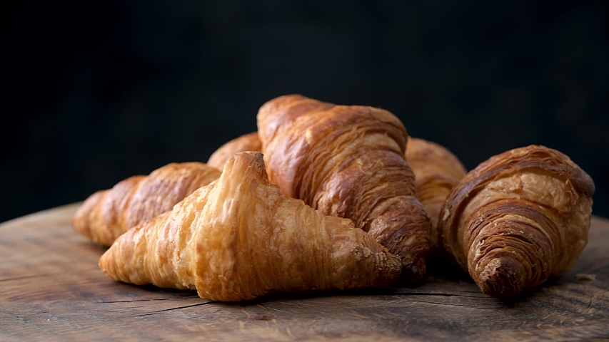 freshly baked croissants on old wooden table Royalty-Free Stock Footage #1046858467