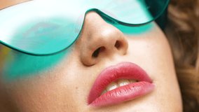 Close up video shot of Woman’s Pretty face in front of Camera, Looking fashionable. Having bright and Colorful makeup. Trendy Eyeglasses on female Model. Beautiful Appearance of Female Model.