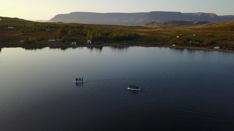 Sunset Aerial Shot Of A Group Of Sup Surfers Floating In Hafravatn Lake In Iceland