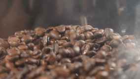 Beans of Coffee Raining in Slow Motion. Conceptual clip of coffee beans, close up. Coffee beans pouring into glass bowl on coffee machine. Side view. grinding machine. Full hd