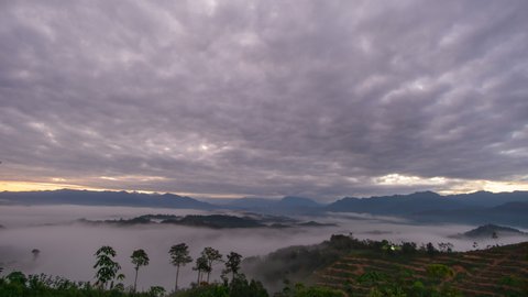 Time lapse : Majestic Mount Kinabalu view with mountains layer below, clouds in motion and foggy morning landscape. Malaysia destinations and nature. 