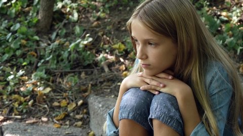 Sad Kid, Thoughtful Bullied Teenager Girl Outdoor in Park,Depression Portrait of Adolescents.